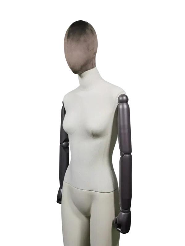 Angled view of a XINTU female mannequin, showing the dark velvet abstract head, light linen torso, and dark adjustable arm.