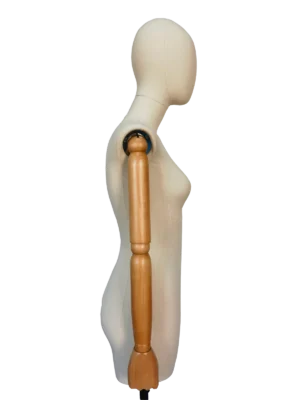 Perfil lateral do torso de um manequim feminino XINTU, apresentando um corpo em tecido branco-sujo, cabeça abstrata e braços articulados em madeira de faia.