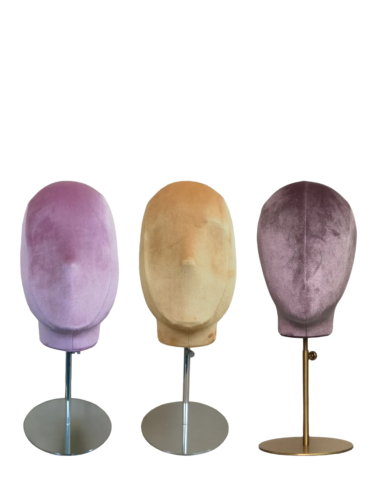 Velvet mannequin heads on adjustable stands in pink, beige and mauve
