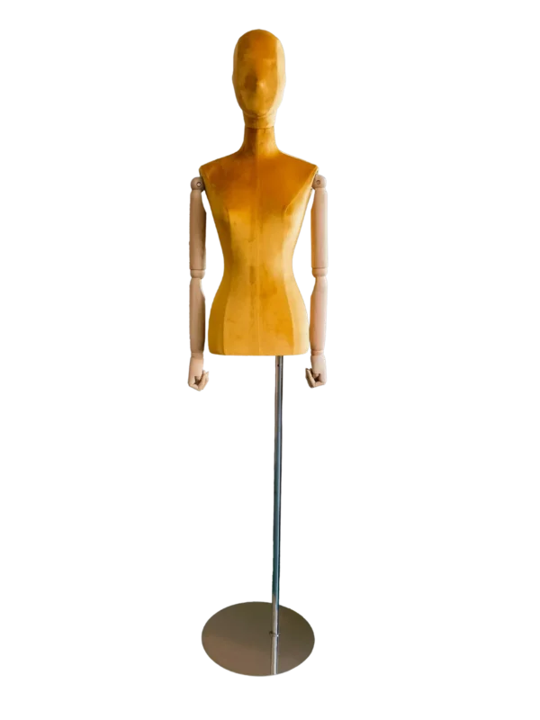 Front view of a XINTU female torso mannequin, upholstered in yellow velvet with an abstract head, wooden arms, and a round metal base.